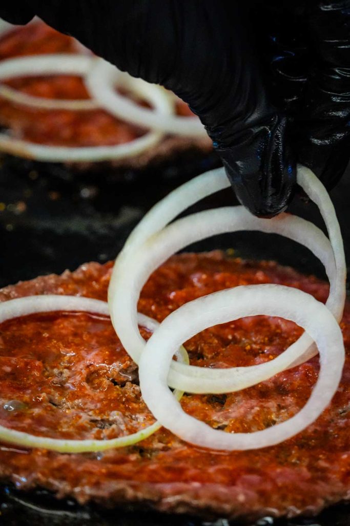 Grilled beef patty at BossBites Sugar Land kitchen