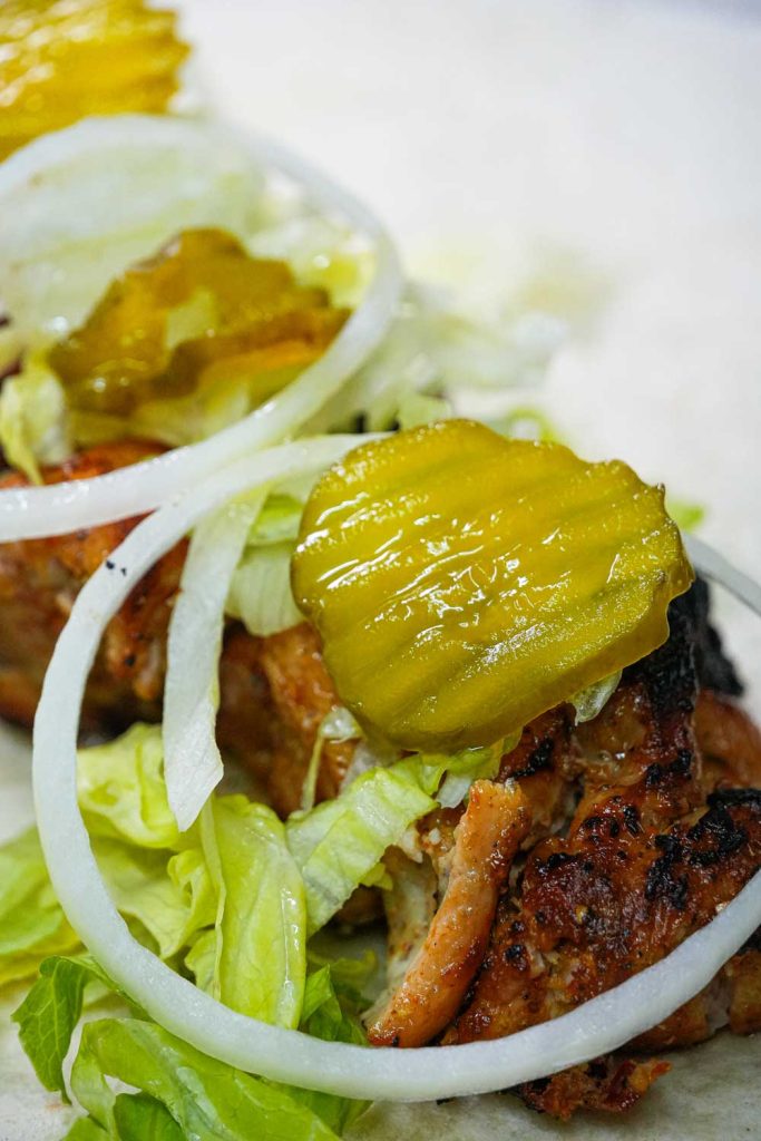 Burger with pickles and fresh toppings BossBites TX