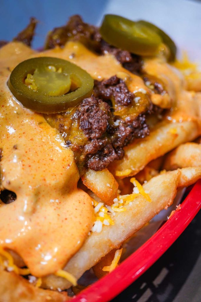 Fully loaded fries with toppings and sauces from Boss Bites