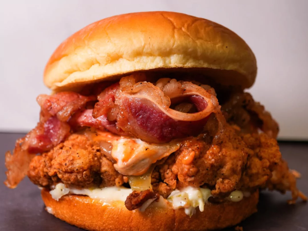 Crispy fried chicken sandwich with bacon and creamy coleslaw on a brioche bun, a perfect option for a meal at Burger Places Near Waterford