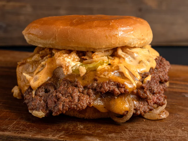 A juicy double cheeseburger with melted cheese, pickles, fried onions, and tangy sauce, served fresh at burger restaurants in Sugar Land