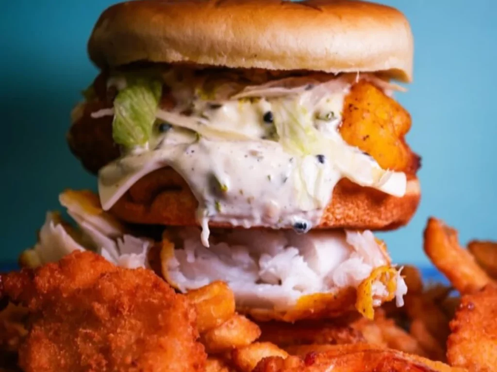Close-up of juicy burgers open after midnight in Woodbridge Estates with fried patties, lettuce, sauce, cheese, and fries