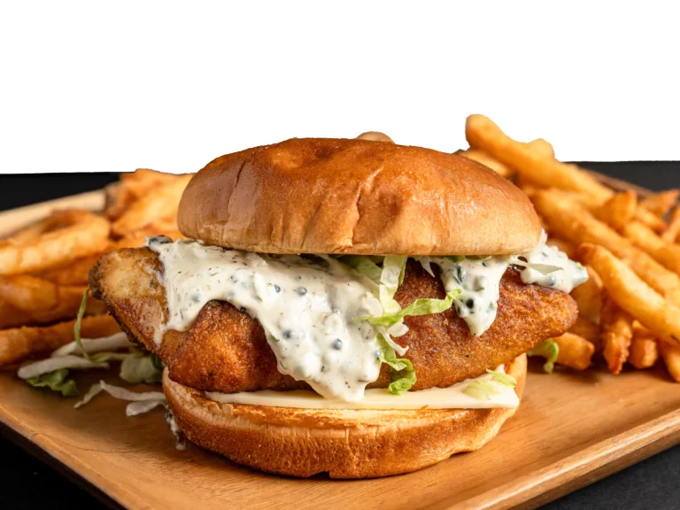 Close-up of a delicious fish burger with lettuce and sauce at Burger Restaurants in Sugar Land