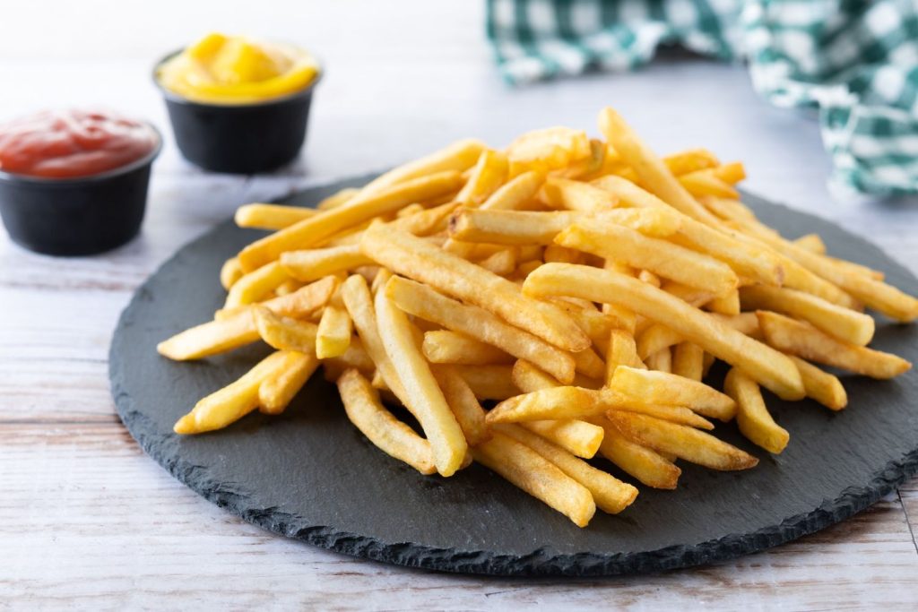 Crispy fries served with ketchup and mustard, a perfect side for the best burgers in Sugar Land.